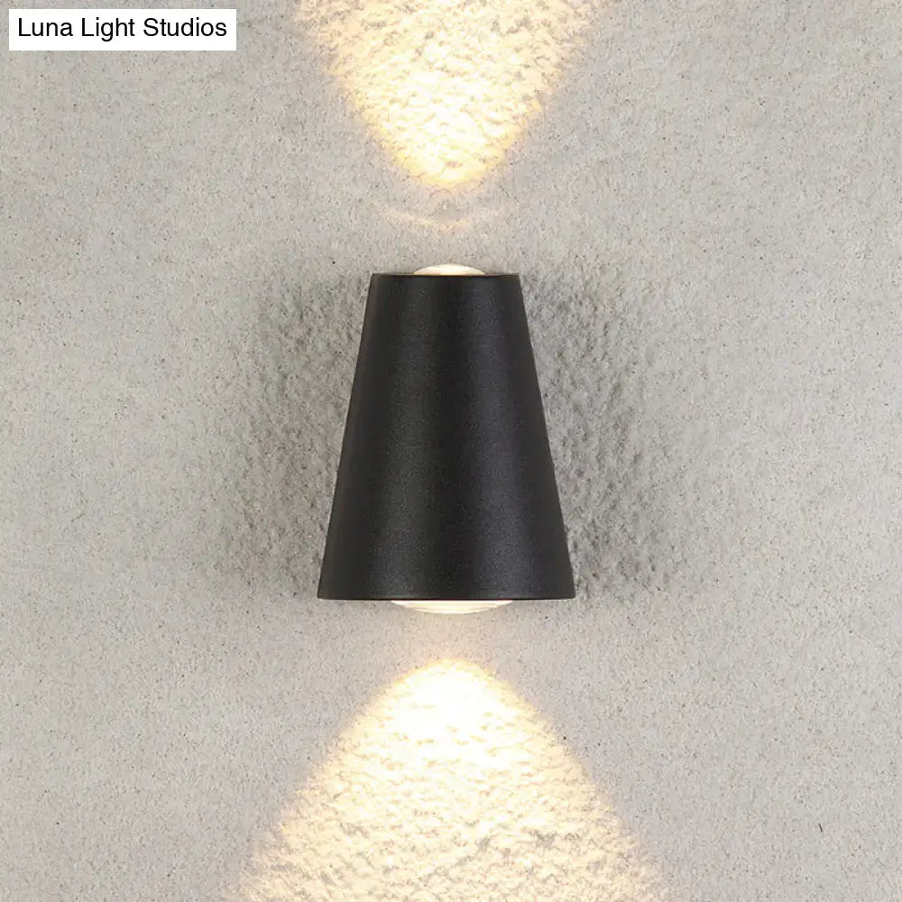 Modern black trapezoid wall light with sleek conical design casting warm light and maximum bulb wattage features