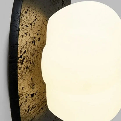 Modern black travertine bedroom wall lights with matte black frame textured cork backplate and oval frosted diffuser