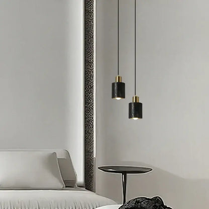Modern black travertine led pendant light with gold accents casting warm glow in minimalist dining room decorbites black travertine