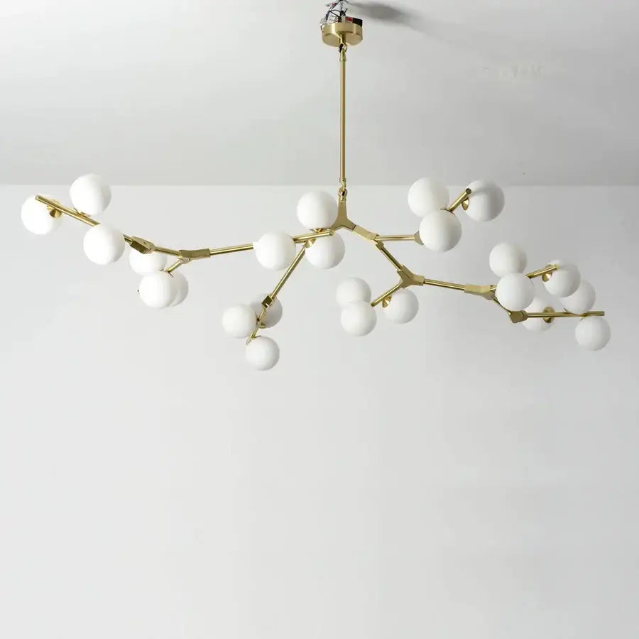 Modern gold-toned branch-style led ceiling light with white glass globes for dining room illumination