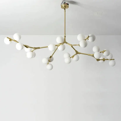 Modern gold-toned branch-style led ceiling light with white glass globes for dining room illumination