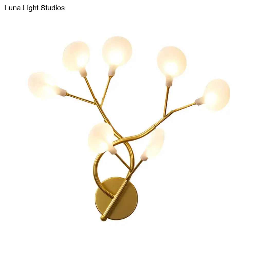 Gold-toned wall light with five frosted glass globe bulbs in a modern tree branch design 20 inch fixture for bedroom