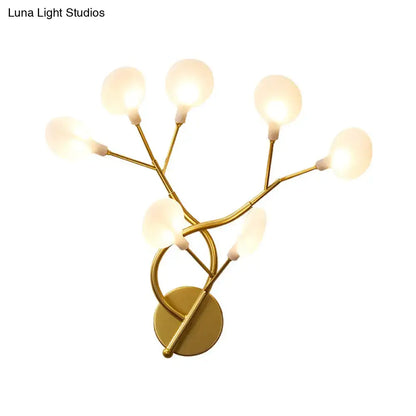 Gold-toned wall light with five frosted glass globe bulbs in a modern tree branch design 20 inch fixture for bedroom