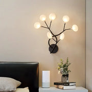 Modern black wrought iron wall light with six frosted glass globes in a tree branch design 24 inch fixture