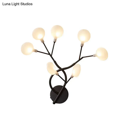Modern black metal wall light with five frosted glass globes in a 6 inch tree branch fixture for bedroom use