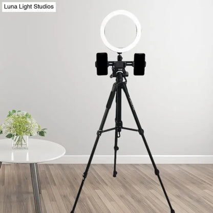 Modern black tripod with round shade ring light and dual smartphone clamps stylish lighting solution for bedroom lamp