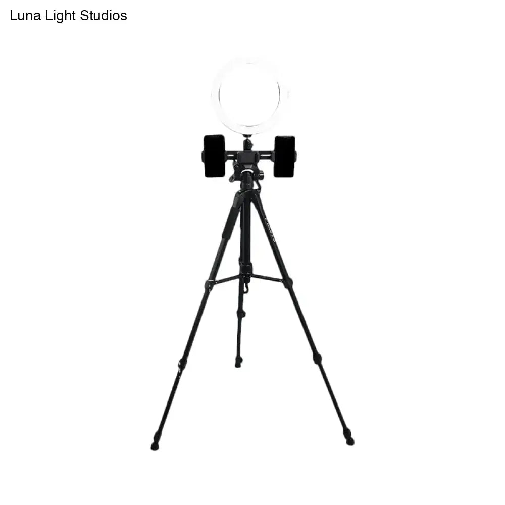 Modern black tripod with round shade ring light and two phone holders offers a stylish lighting solution for bedrooms