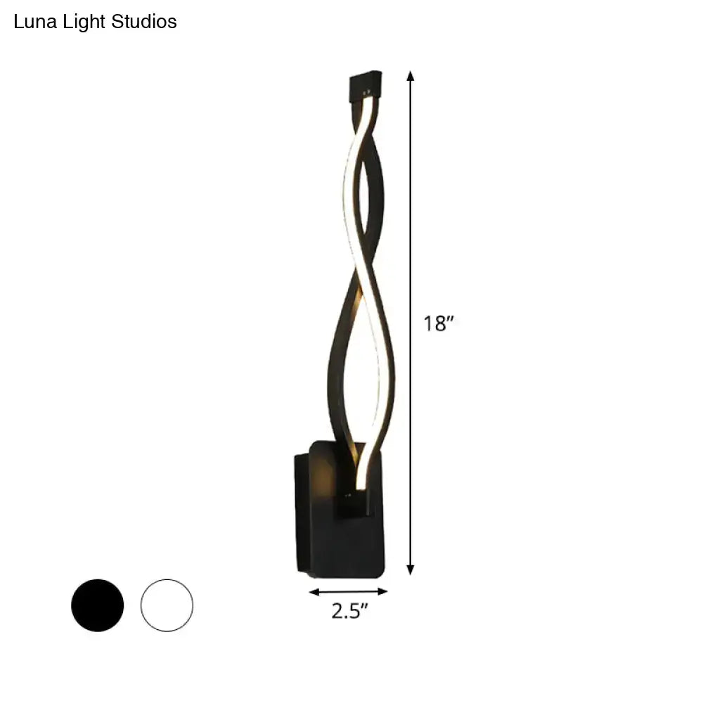 Modern black and white twisted led stairway sconce with sleek design emitting warm white light for bedroom use