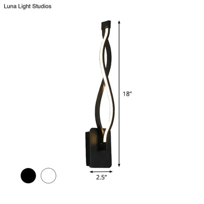 Modern black and white twisted led stairway sconce with sleek design emitting warm white light for bedroom use
