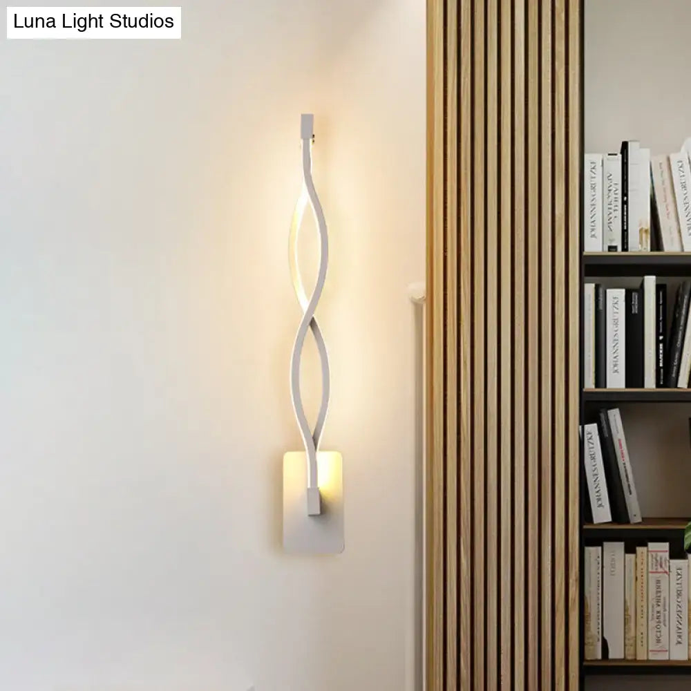 Modern white led wall sconce with a sleek twisted design and warm white light for bedroom stairway lighting