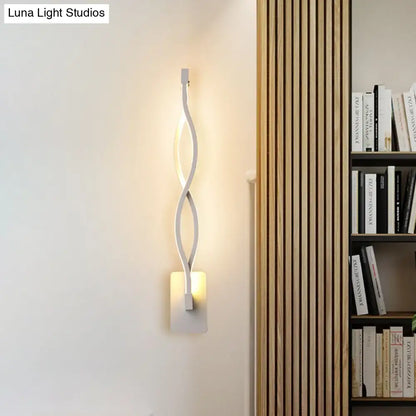 Modern white led wall sconce with a sleek twisted design and warm white light for bedroom stairway lighting
