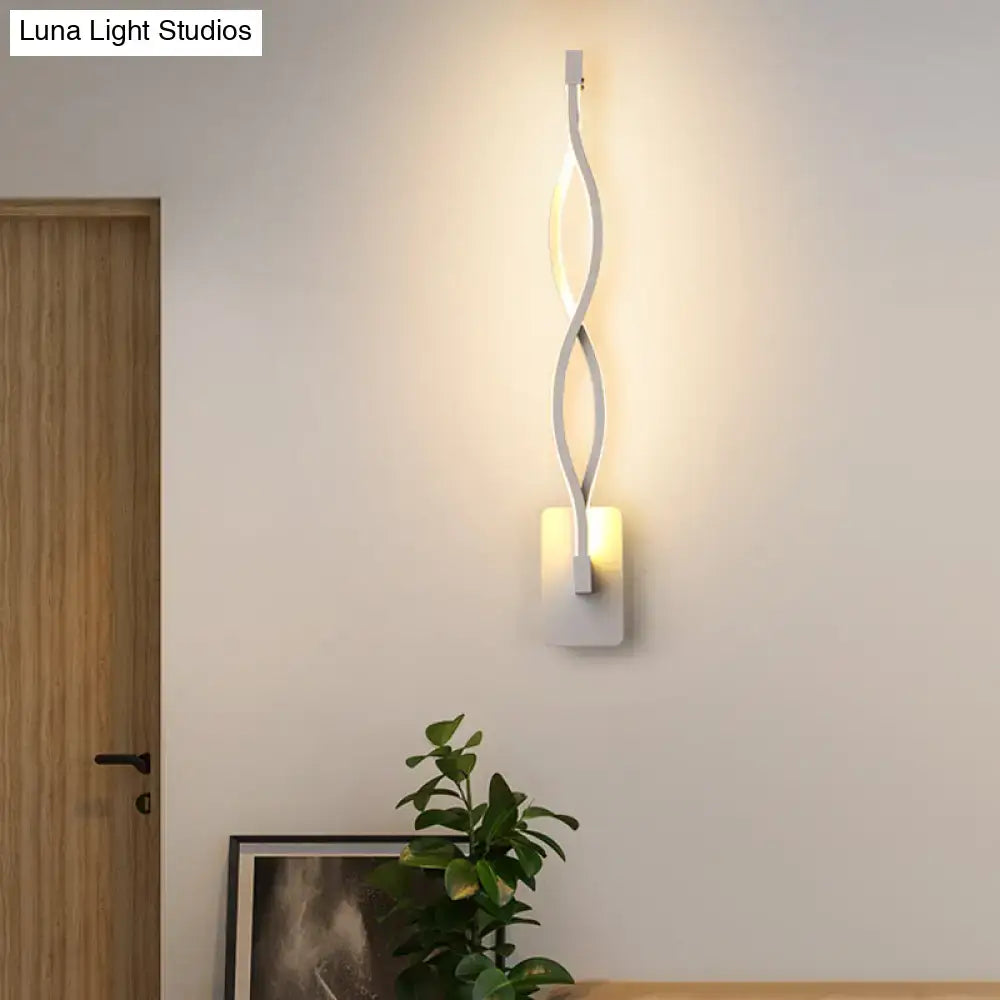 Modern black and white twisted led stairway sconce with warm white light and sleek ambient lighting design