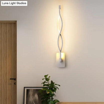 Modern black and white twisted led stairway sconce with warm white light and sleek ambient lighting design