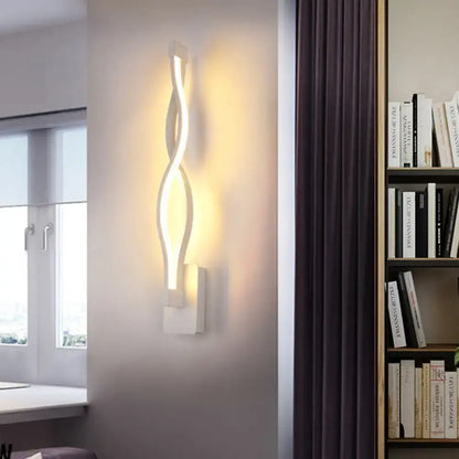 Modern black twisted led stairway sconce with sleek white design emitting warm white light for bedroom use
