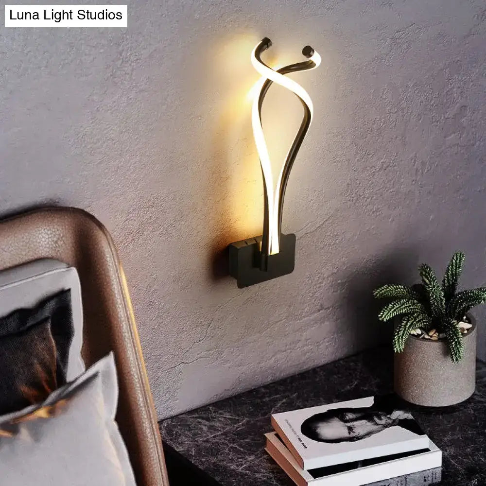 Modern black twisted spiral led wall sconce with gold-toned finish and warm ambient lighting for bedroom use
