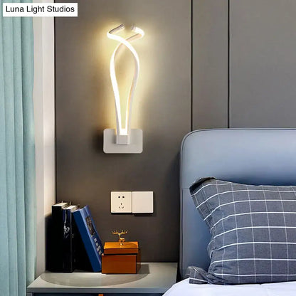 Modern white led wall sconce with sleek twisted design complements bedroom lighting with contemporary style