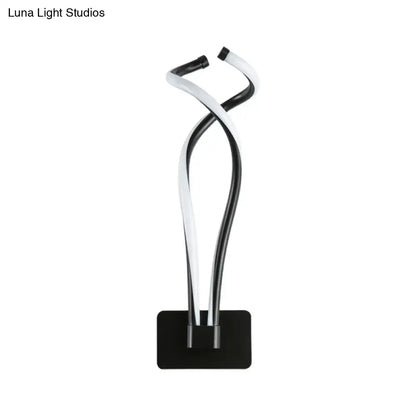 Modern black and white twisted led table lamp with sleek minimalist design for bedroom lighting use