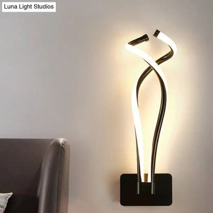 Modern black and white led wall sconce with a sleek twisted spiral design for bedroom lighting