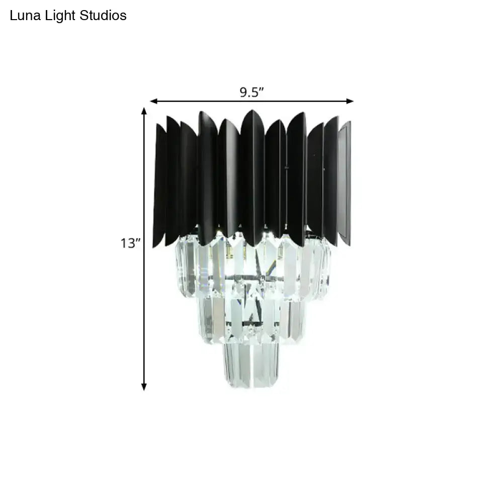 Modern black wall sconce with clear crystal prisms and tiered design as a wall mounted light for bedroom use