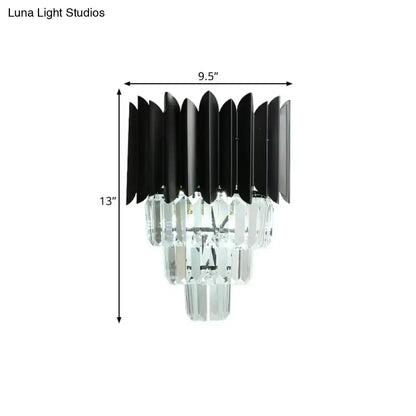 Modern black wall sconce with clear crystal prisms and tiered design as a wall mounted light for bedroom use