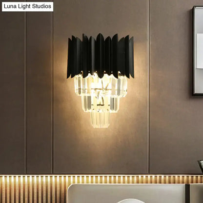 Modern black wall sconce with clear crystal prisms and layered design for wall mounted bedroom light