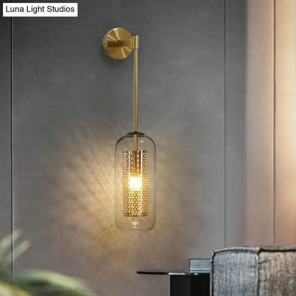 Modern black wall sconce featuring a gold-toned wire mesh honeycomb design with clear glass housing for stairway lighting