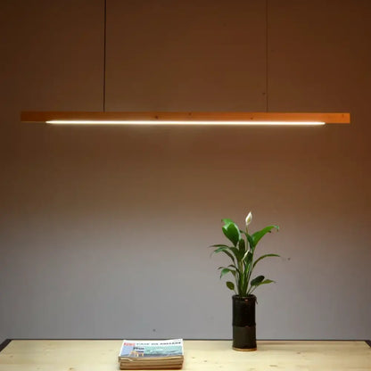 Modern black walnut led pendant light with warm-toned wooden linear design for black walnut dining decorbites