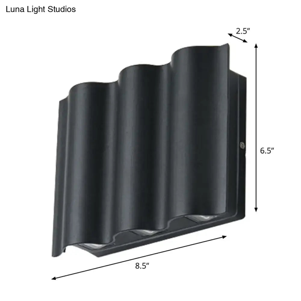 Modern black wavy metal shade wall light featuring a sleek outdoor design with warm white light for patios