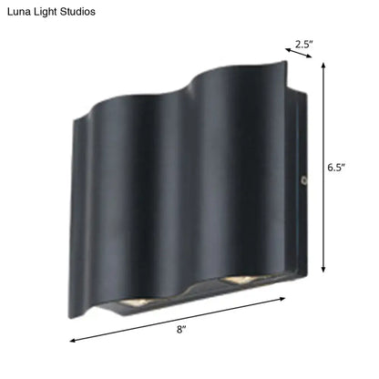 Black wavy metal shade wall light with sleek modern design emitting warm white light for patio use