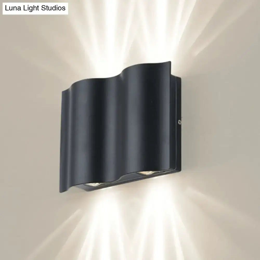 Modern black wavy metal shade wall light with sleek design emitting warm white light for patio use