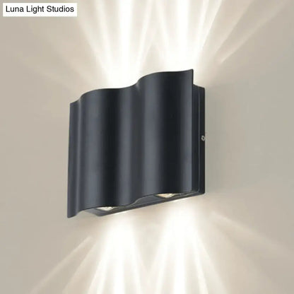 Modern black wavy metal shade wall light with sleek design emitting warm white light for patio use