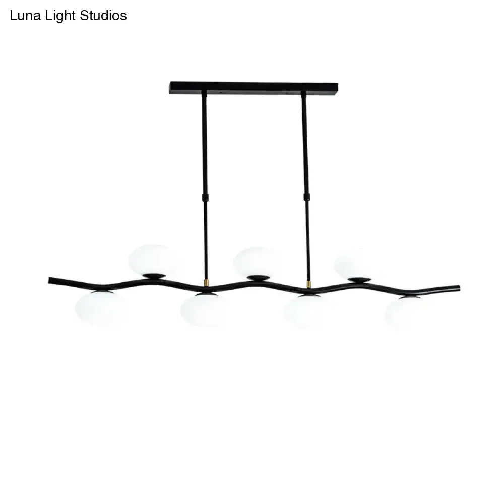 DecorBites modern black wavy pendant light with five white glass ceiling globes and extendable rods for island lighting