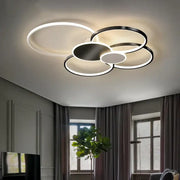 Modern black and white acrylic chandelier light with overlapping circular rings and sleek metallic finish for living room
