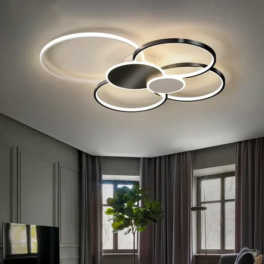 Modern black and white acrylic chandelier light with overlapping circular rings and sleek metallic finish for living room