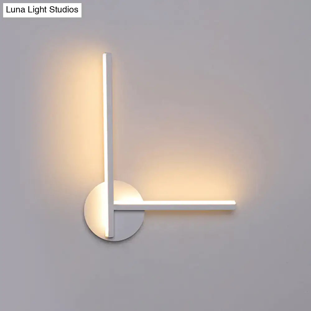 Modern black and white acrylic cross wall sconce with l-shaped design and warm white ambient lighting for bedroom use