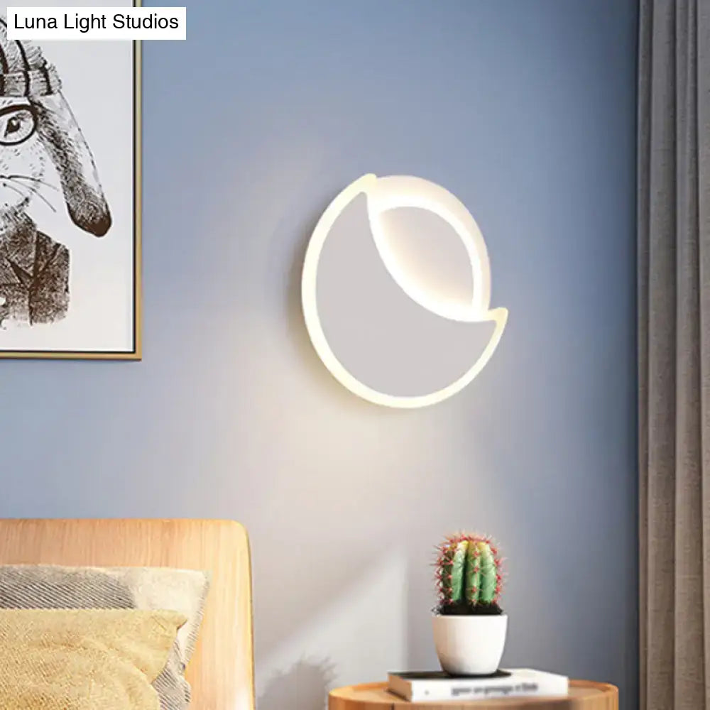 Modern black and white acrylic wall sconce with a crescent moon shape and sleek minimalist design for bedroom lighting