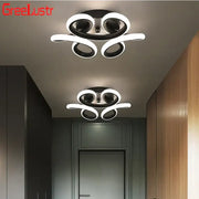 Modern black and white decorbites acrylic led ceiling light with sleek swirling ring design for bedroom decor