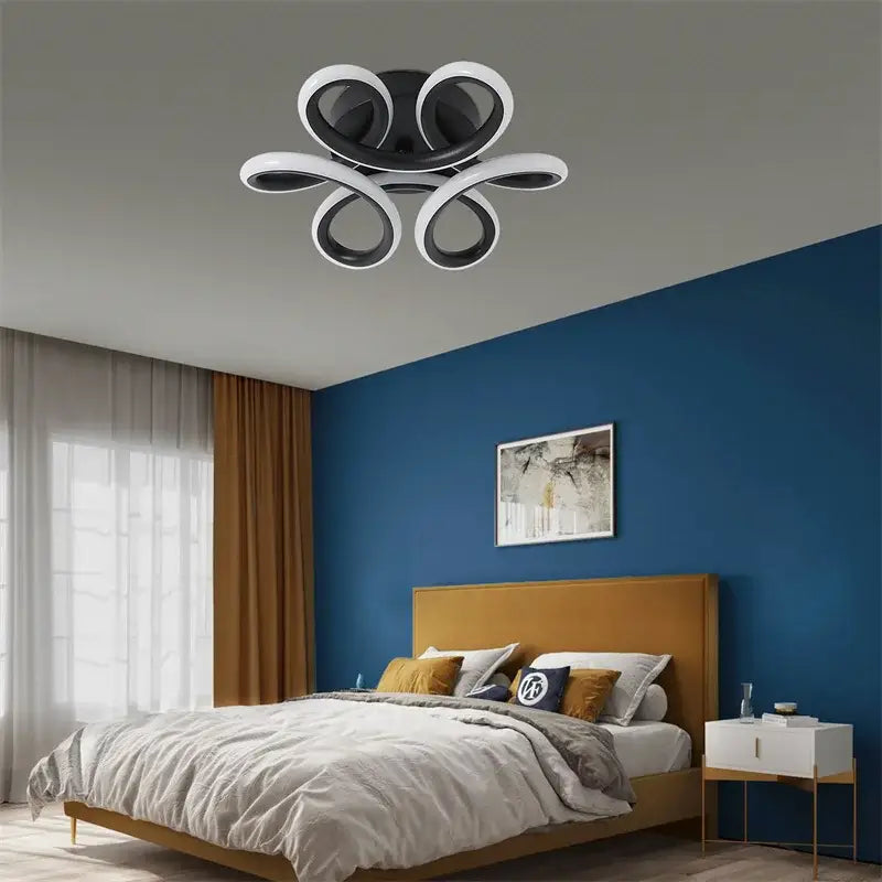 Modern black and white decorbites acrylic led ceiling light with a sleek flower-like swirl design for bedroom decor