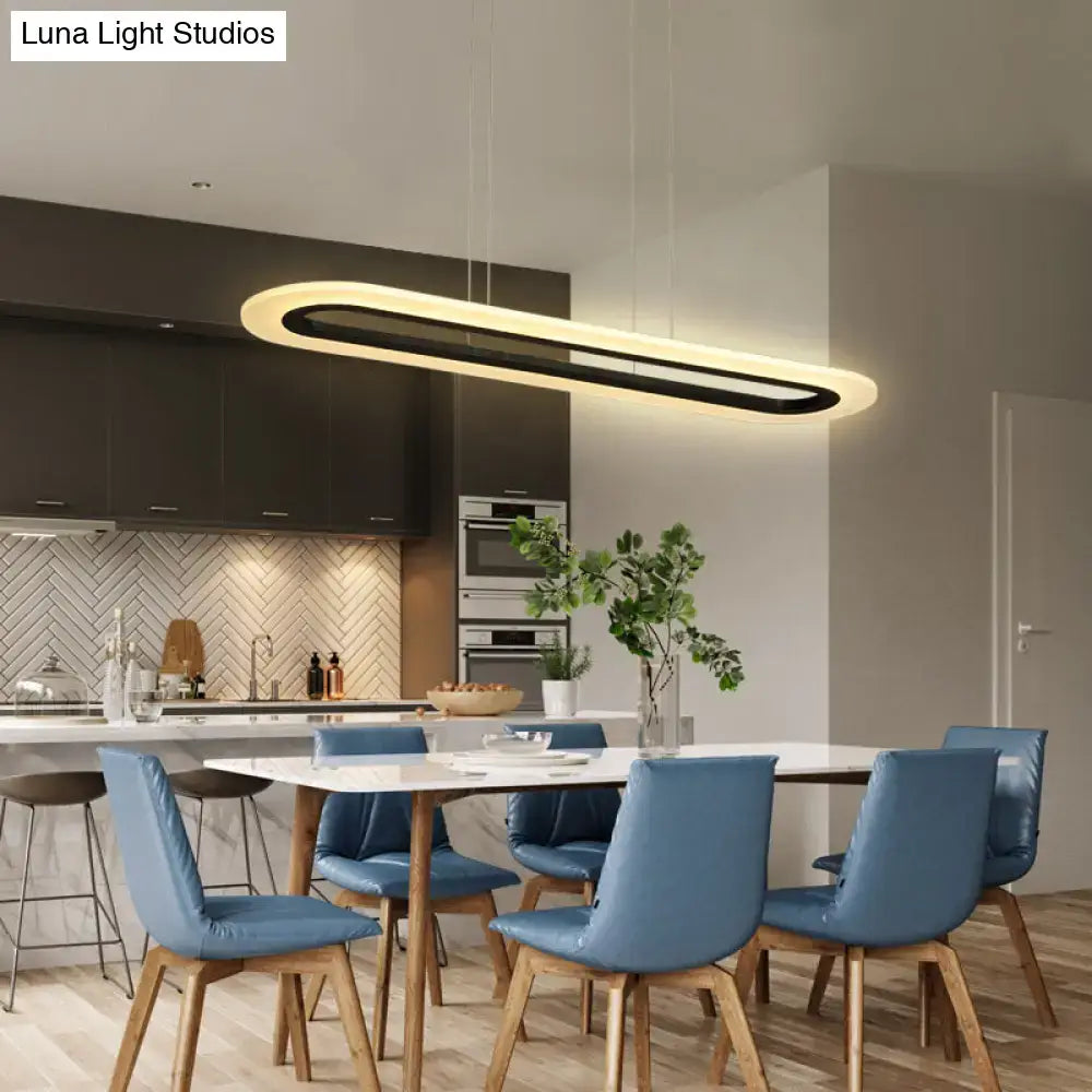 Modern oval pendant light fixture with sleek black and warm white acrylic oblong design and remote control features