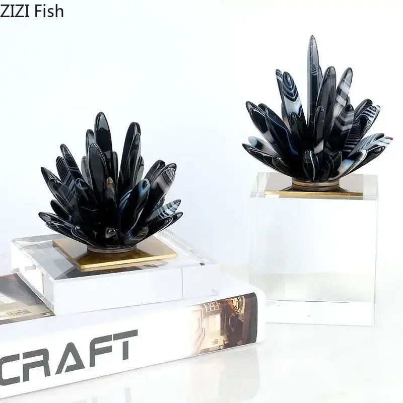 Modern black agate flower crystal art featuring black and white striped agate plant sculptures on gold-toned bases