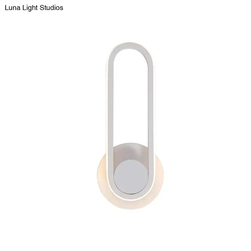 Minimalist black and white aluminum frame wall lamp with sleek oval design providing warm white light for bedroom sconce