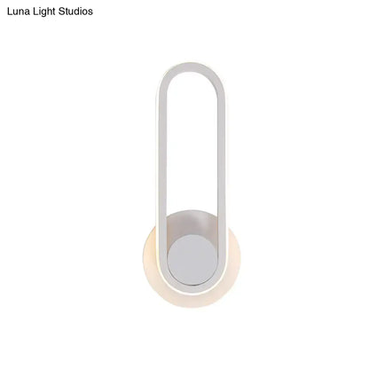 Minimalist black and white aluminum frame wall lamp with sleek oval design providing warm white light for bedroom sconce