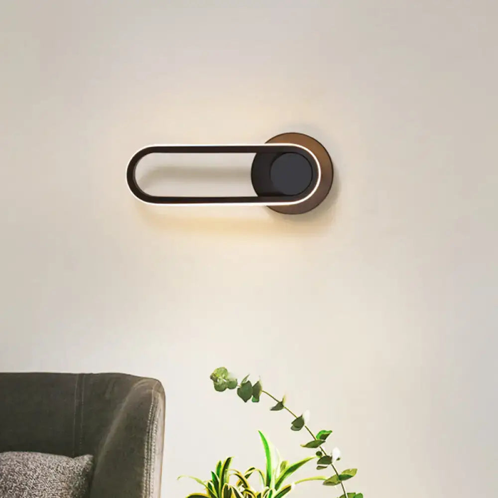 Modern black and white aluminum frame wall lamp with sleek brass finish and warm white light bedroom sconce