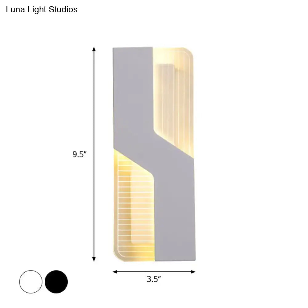 Modern gray and illuminated yellow led wall mount light with a sleek angular design for bedroom use
