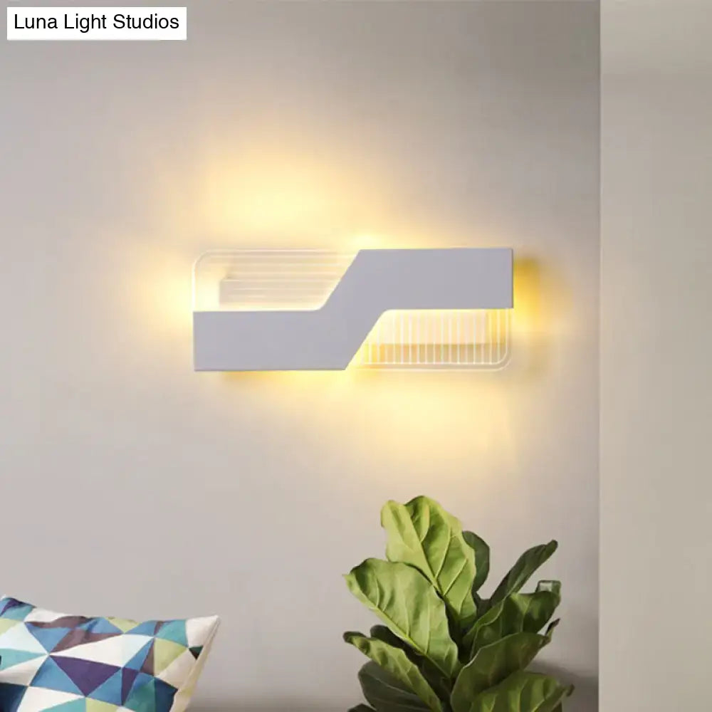 Modern black and white angular led wall mount light with sleek design and warm yellow light for bedroom sconce