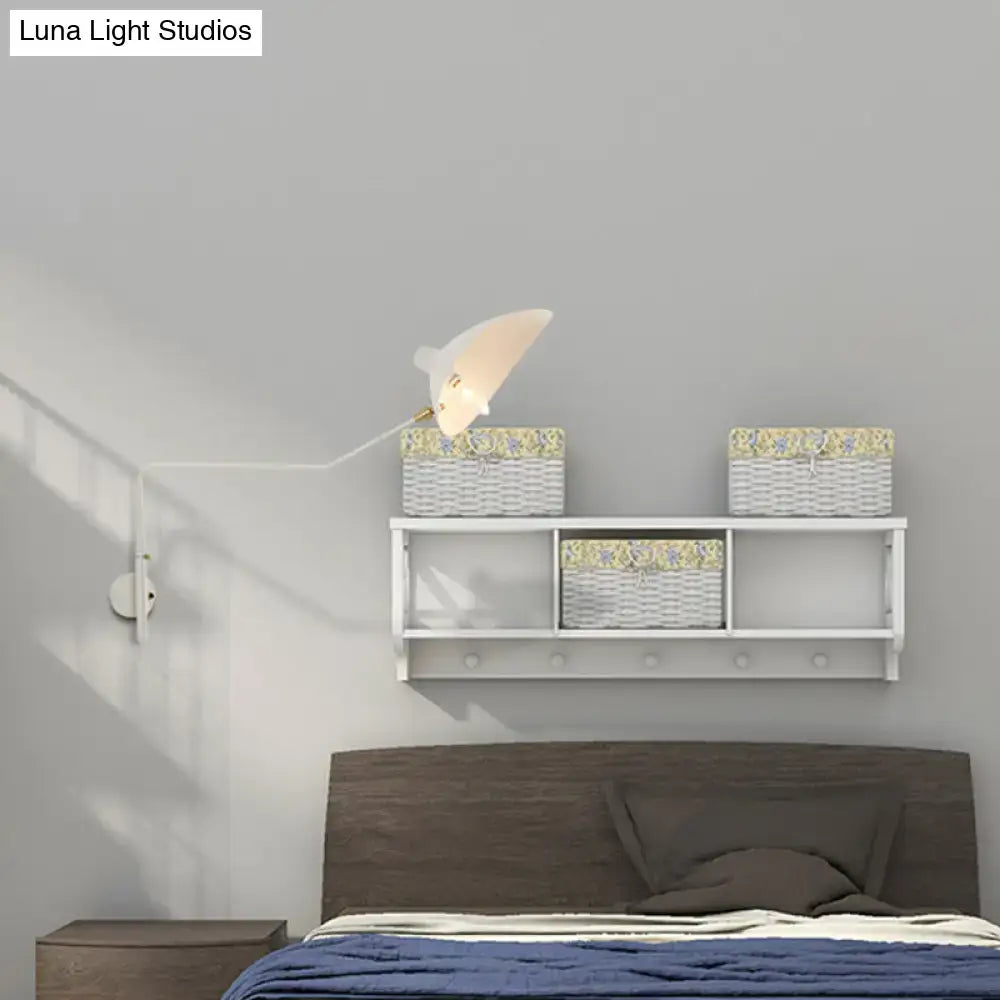 White wall-mounted shelf with three wicker baskets and floral lining paired with modern black and white wall sconce light fixture for living room