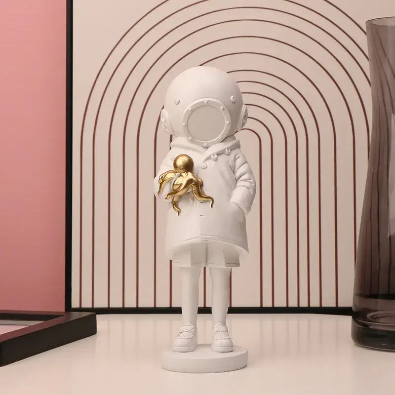 Modern black and white astronaut diver sculpture ornament featuring a white figurine holding a golden octopus for office decor