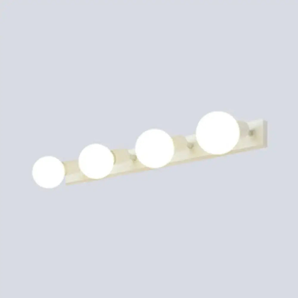 Off-white bedroom vanity light fixture with four exposed round globe bulbs in modern black and white design