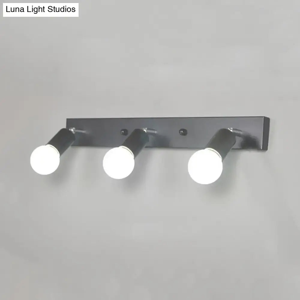 Modern black metal bedroom vanity light with three adjustable exposed bulb spotlights in black white design
