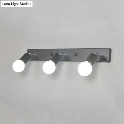 Modern black metal bedroom vanity light with three adjustable exposed bulb spotlights in black white design